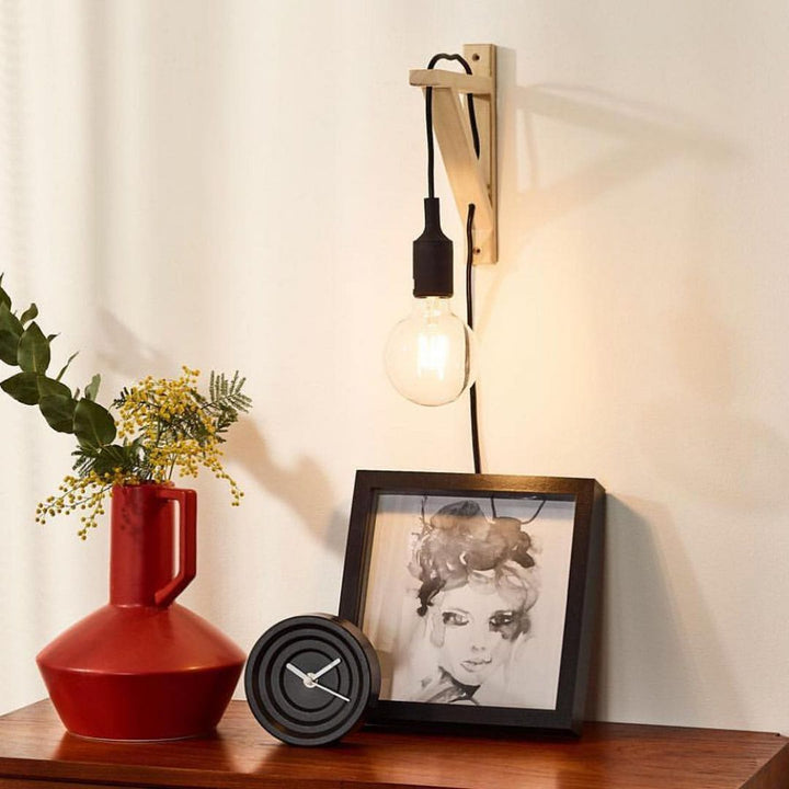 Minimalist Wall-Mounted Bedside Light with Exposed Bulb