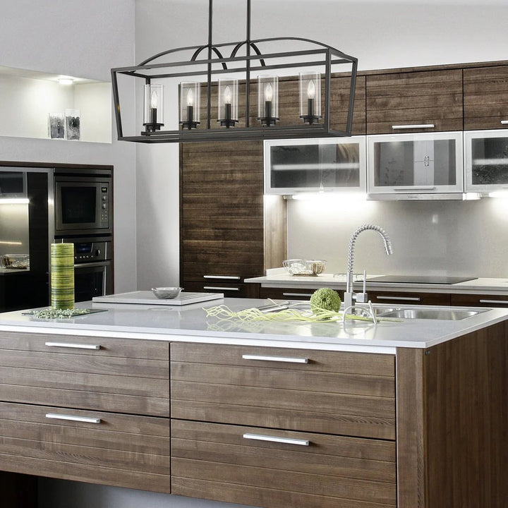 A modern industrial chandelier with a rectangular metal frame and glass cylinder shades, mounted on a ceiling in a stylish kitchen setting.