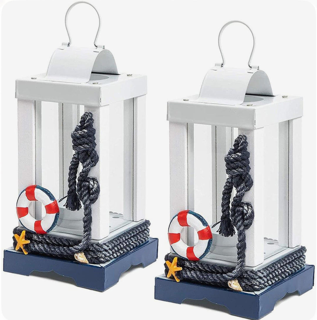 Nautical decorative lantern in white and navy with rope, lifebuoy, and starfish accents