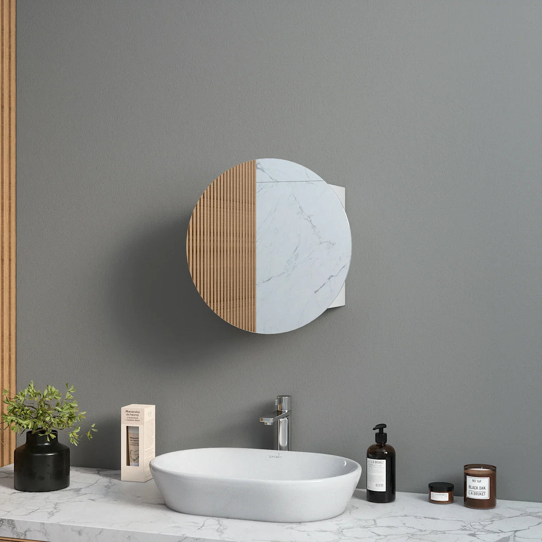 Round bathroom mirror cabinet with wood and marble finish mounted above white sink