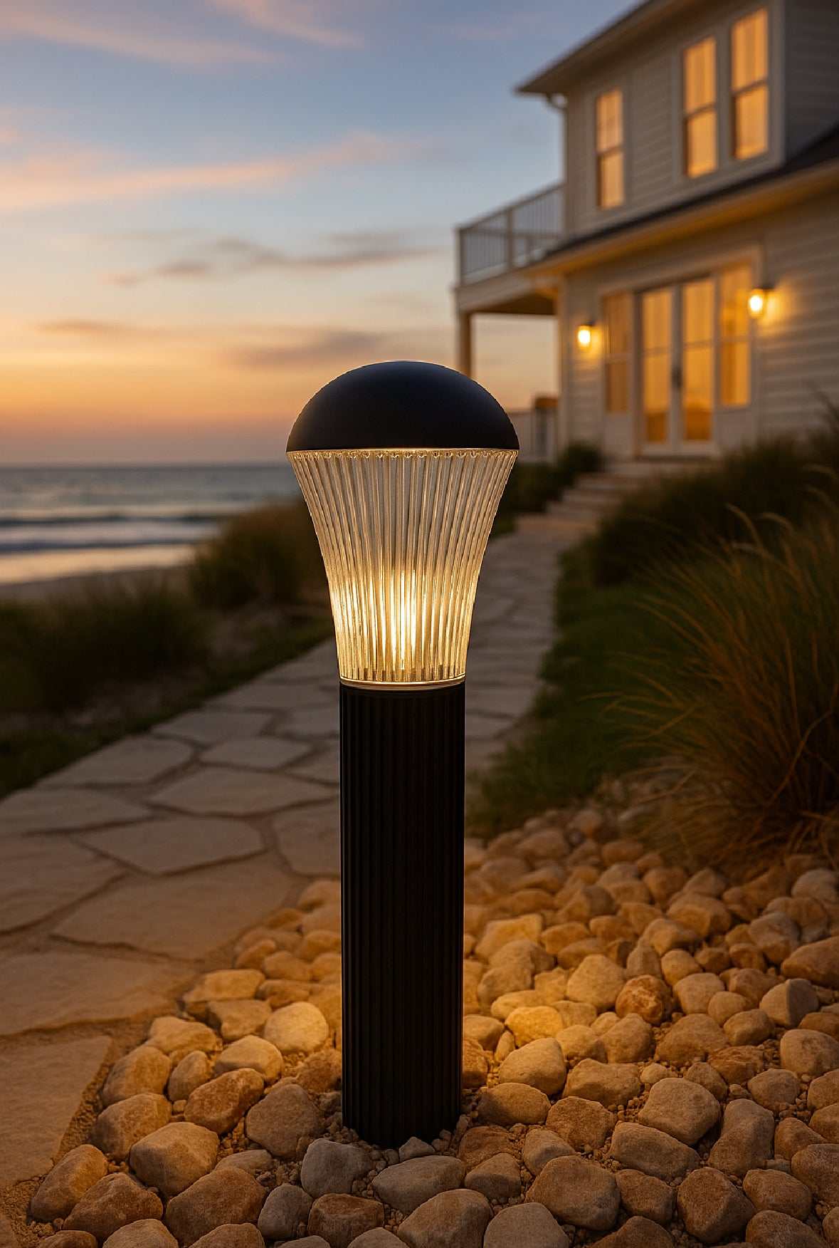 Modern bollard light installed along a pathway