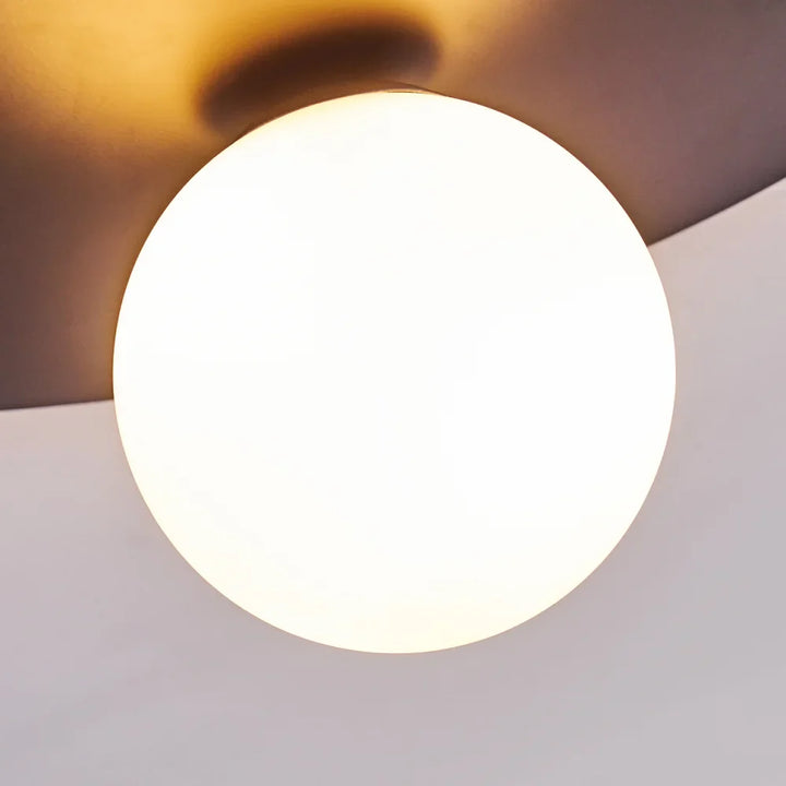 Modern Globe Ceiling Light with Black Disc Design