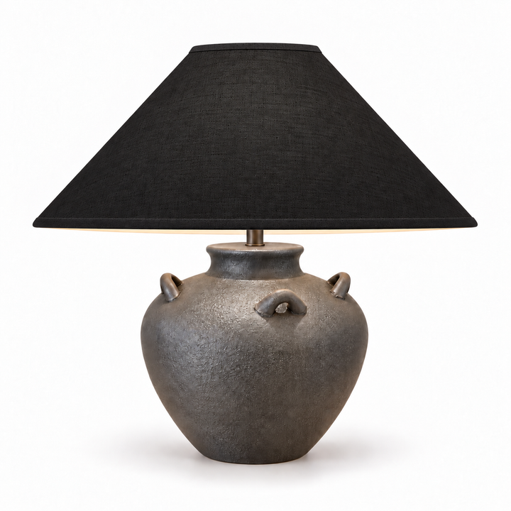 Table lamp with a textured charcoal-gray ceramic base and wide black fabric shade