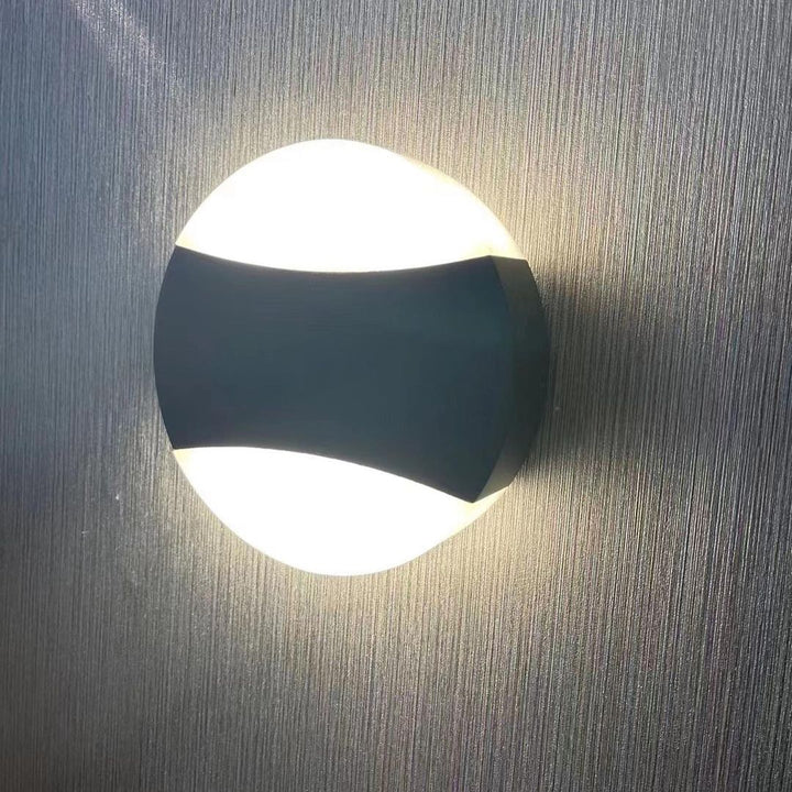 Modern LED Wall Light with Circular Design and Black Accents