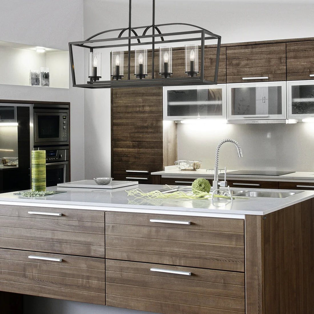 A modern industrial chandelier with a rectangular metal frame and glass cylinder shades, mounted on a ceiling in a stylish kitchen setting.
