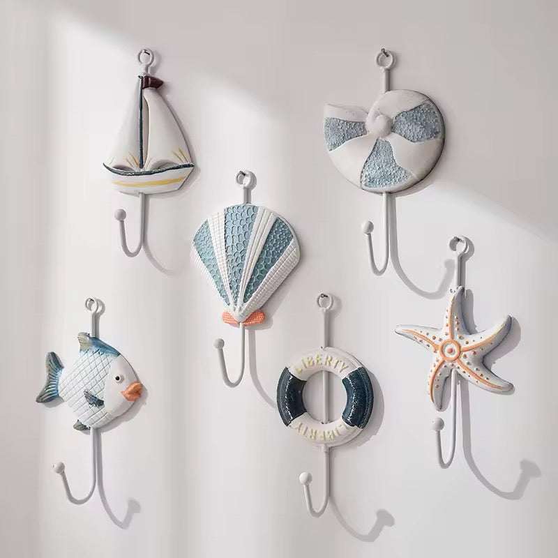 Set of 3 nautical wall hooks featuring fish, starfish, and lighthouse designs