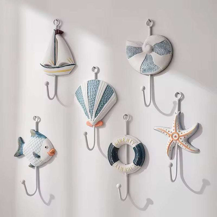 Set of 3 nautical wall hooks featuring fish, starfish, and lighthouse designs