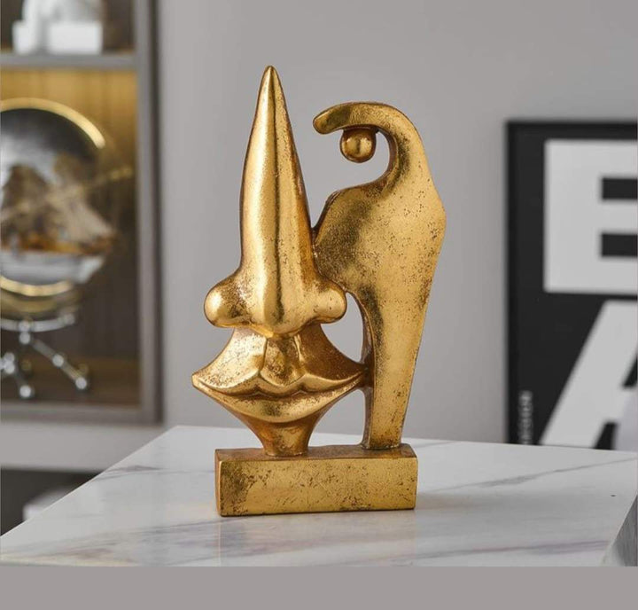 Abstract gold face sculptures with bold shapes and modern design for home decor