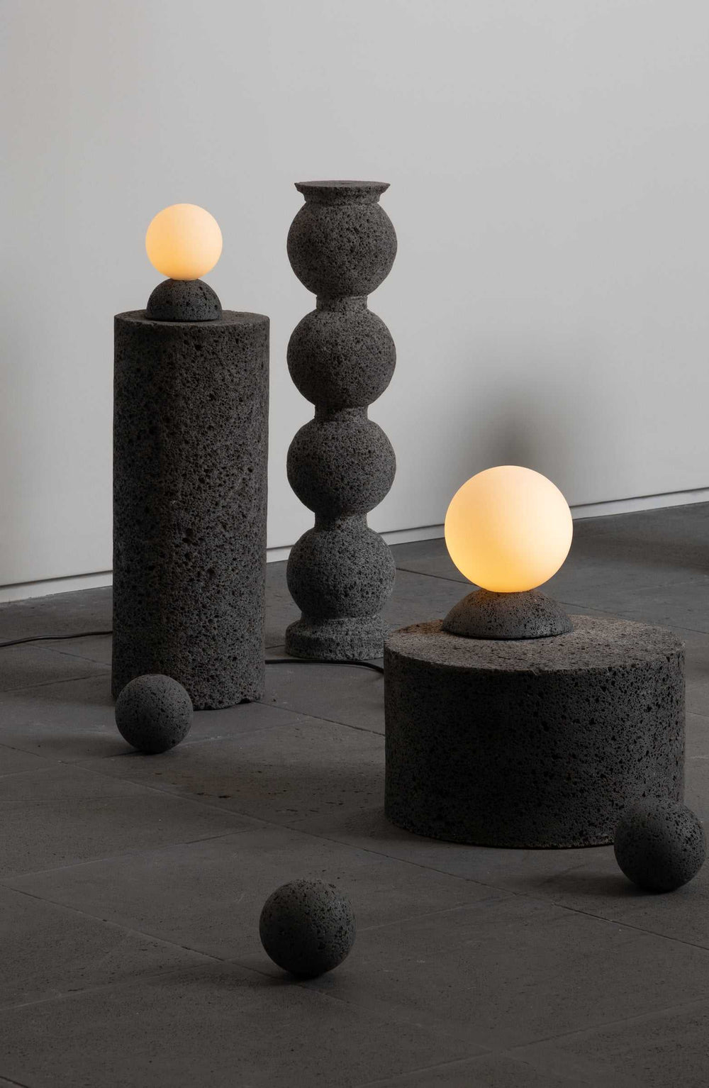 Modern table lights with concrete bases and glass globes for contemporary decor