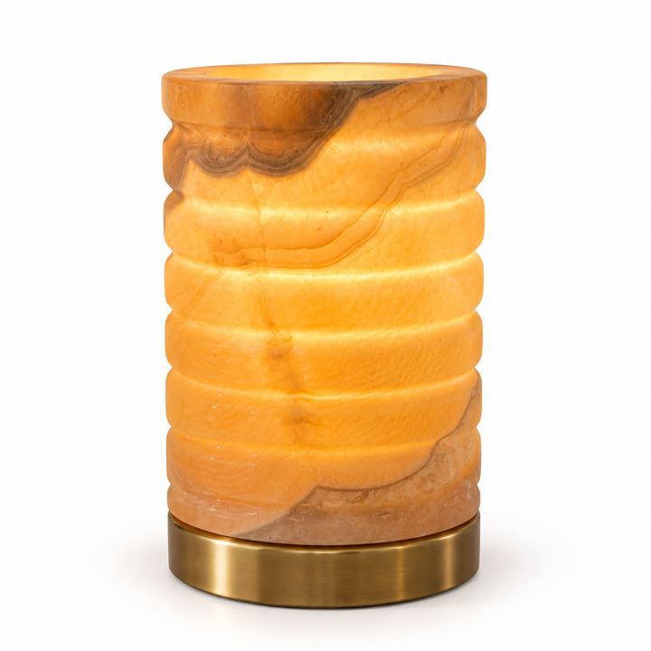 Cylindrical amber stone table lamp with metal base