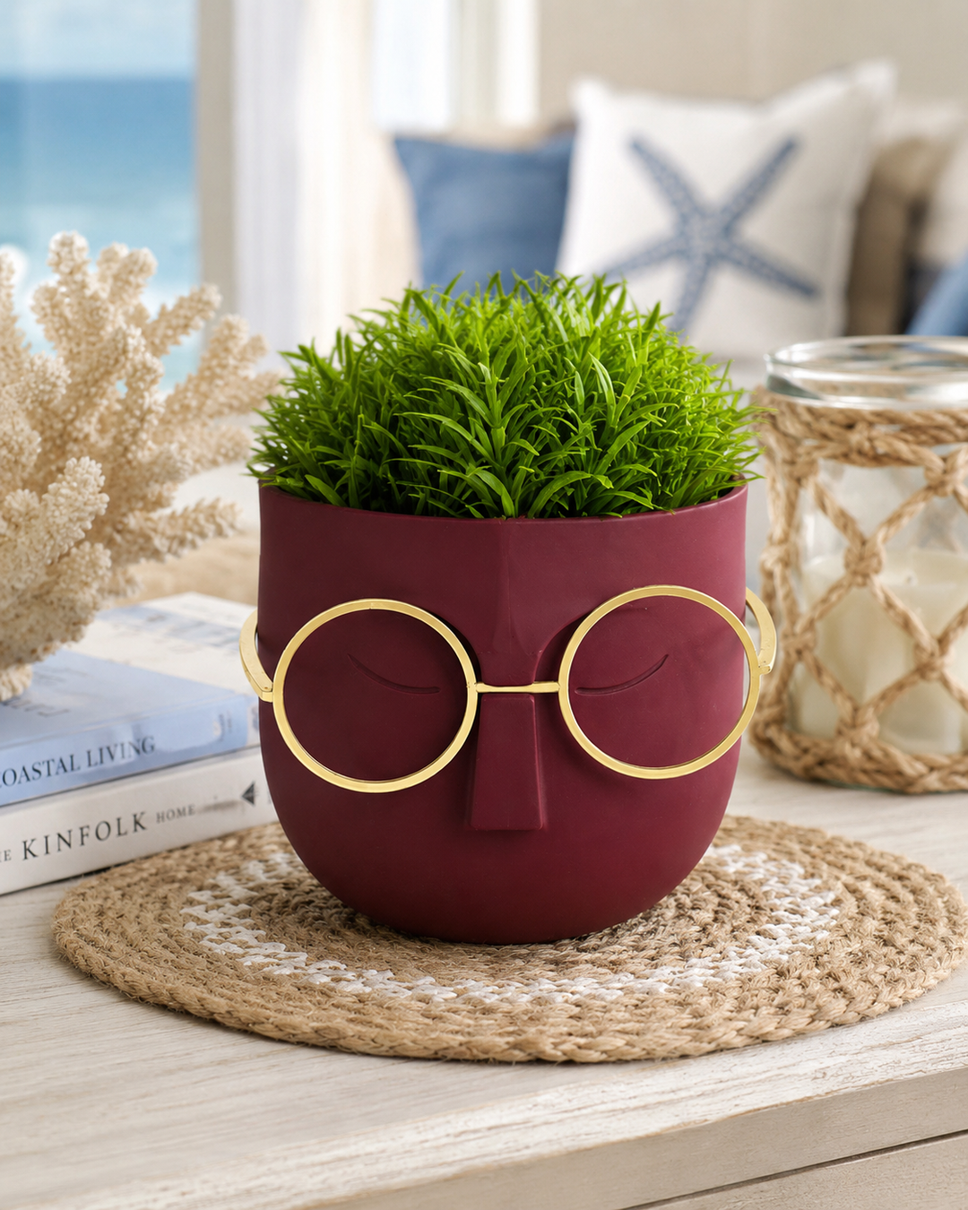 Modern decorative face planter with gold glasses and artificial green plant.