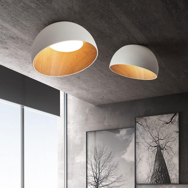 Modern white dome ceiling lights with warm wood interiors mounted on a dark textured ceiling