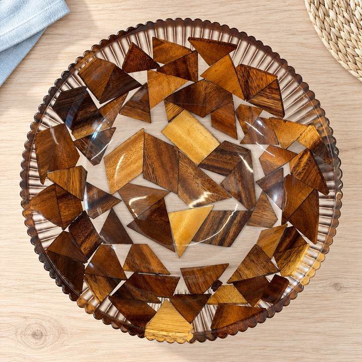 A decorative bowl with a geometric design, inlaid with wood.
