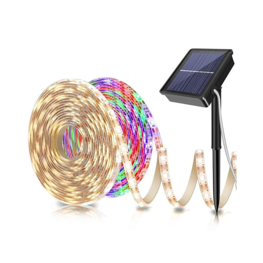 Coiled flexible LED strip lights beside a solar panel with a ground stake; warm-white and multicolor LEDs are shown
