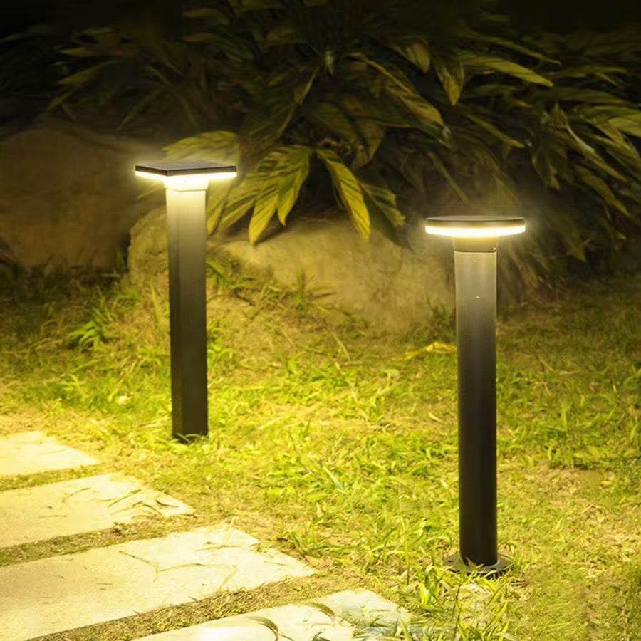 Minimalist LED pathway bollard light illuminating modern outdoor garden path
