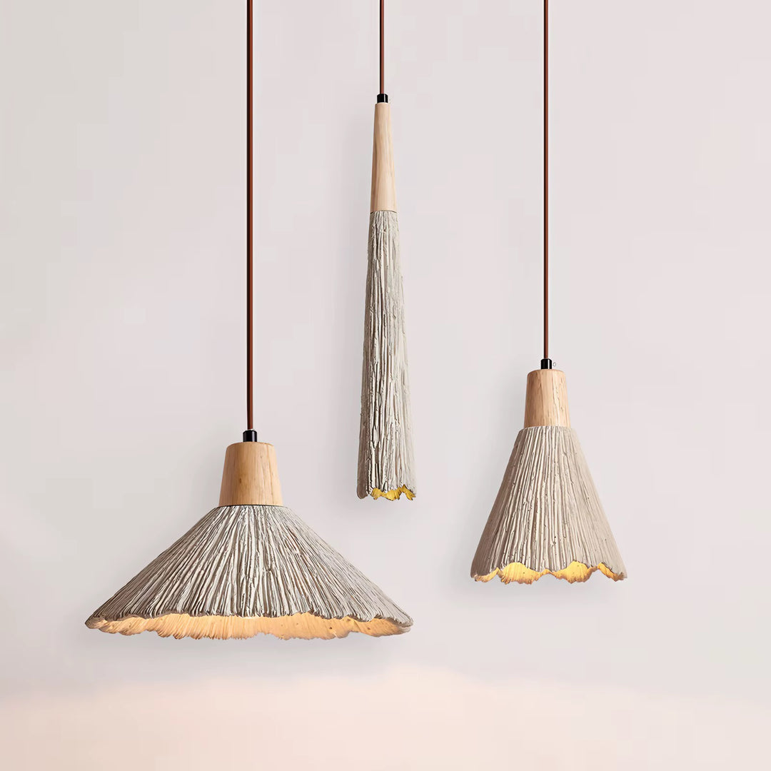 Three hanging pendant lights with beige thread-wrapped shades, natural wood-toned tops, and fringed edges against a pale wall.