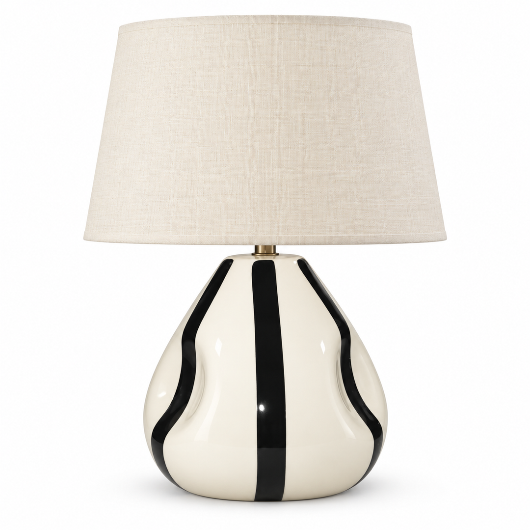 Cream ceramic table lamp with bold black stripes and a neutral fabric shade