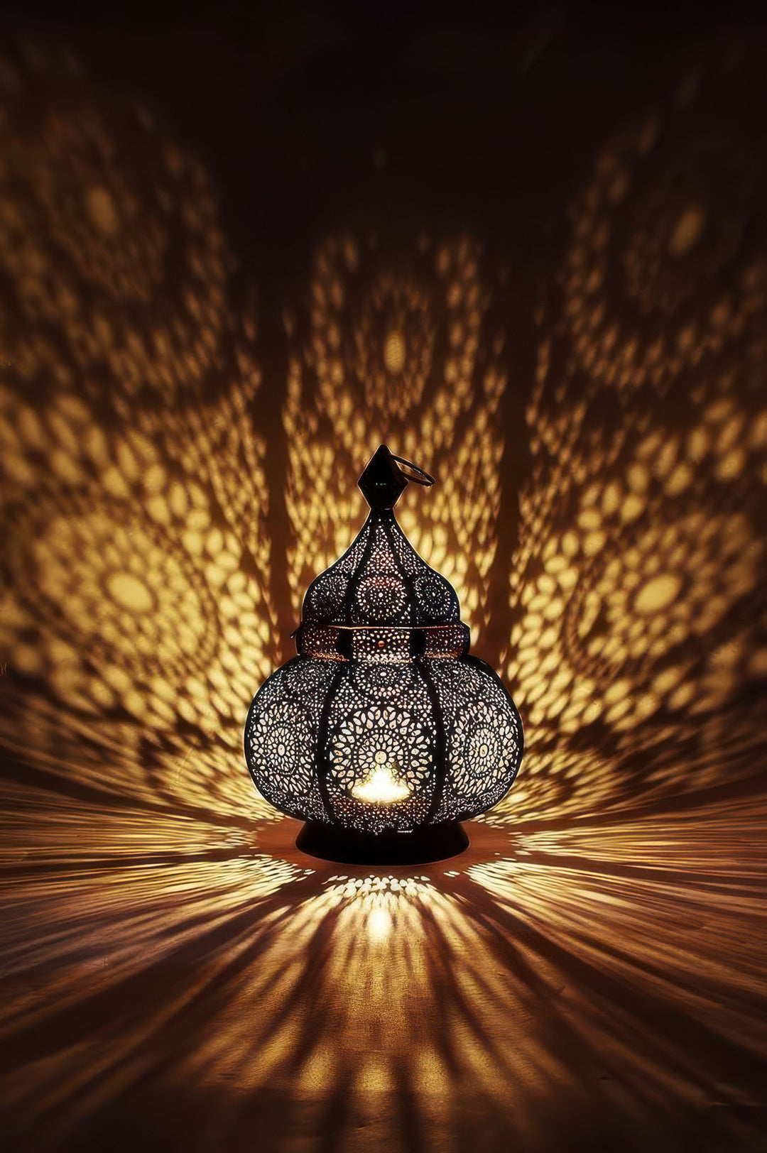 Glowing Moroccan lantern light casting intricate patterns on canvas with MDF frame and glass front.