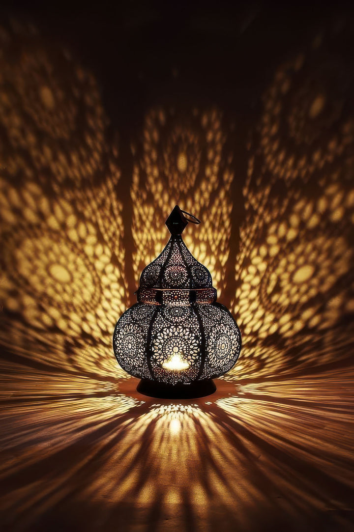 Glowing Moroccan lantern light casting intricate patterns on canvas with MDF frame and glass front.