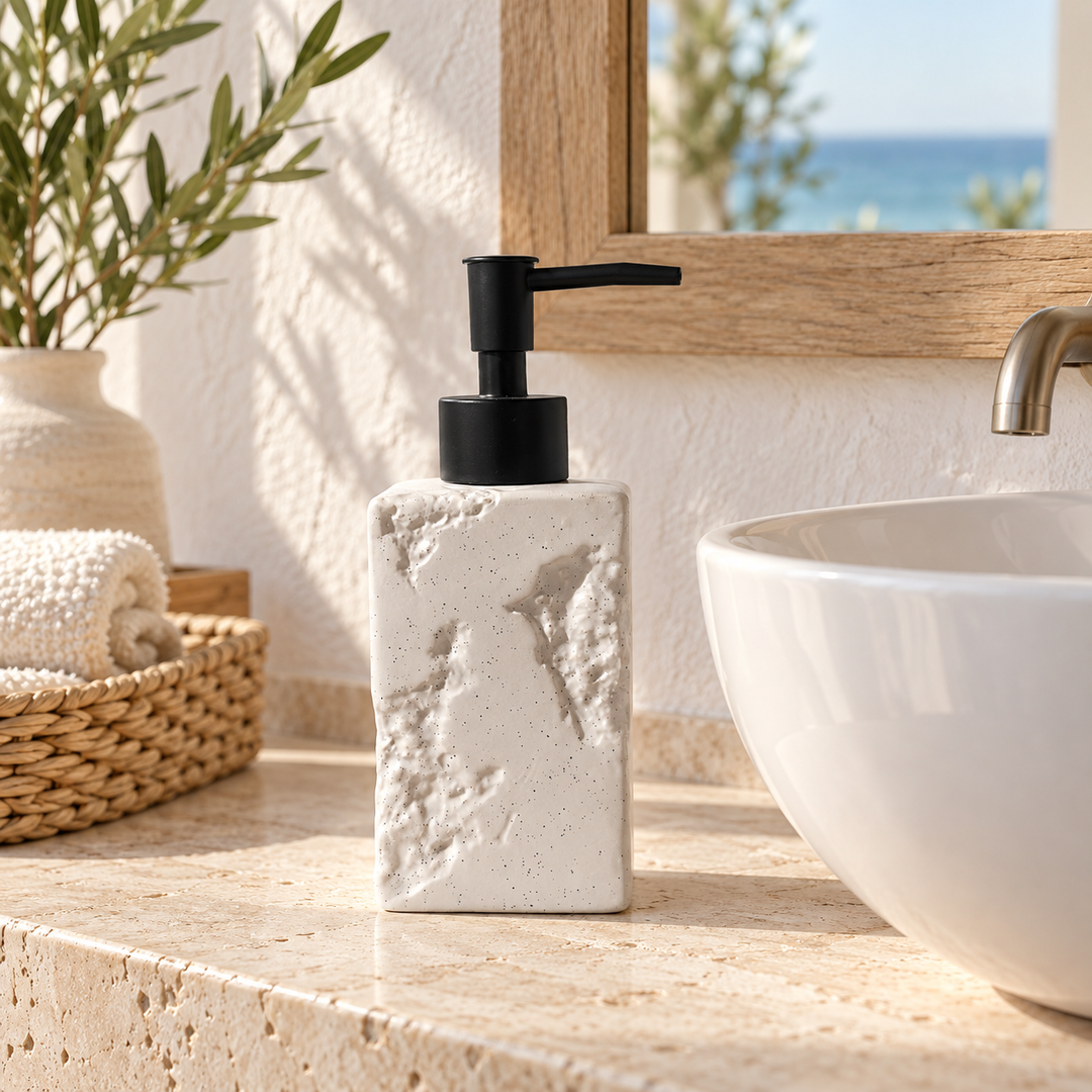 Textured white soap dispenser with black pump beside a bathroom basin