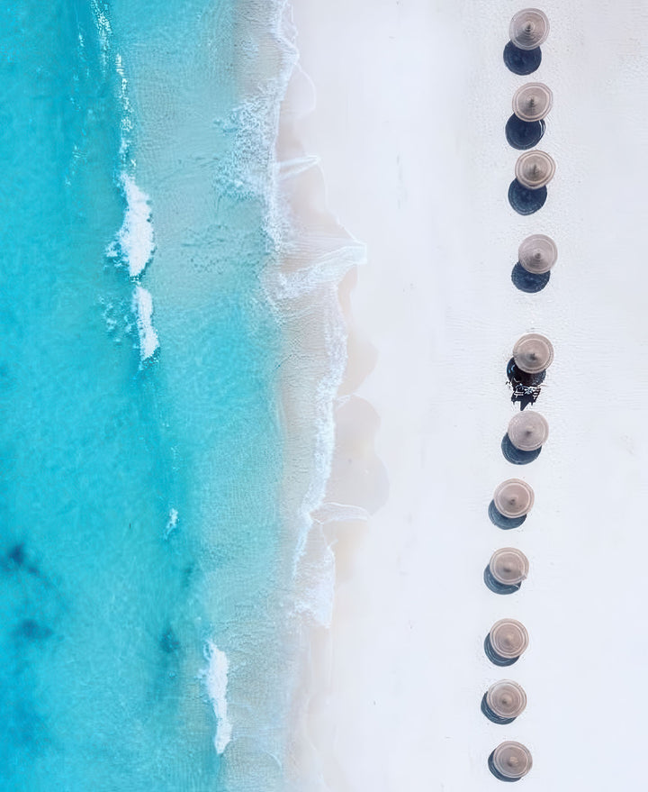 Aerial view of beach umbrellas on turquoise ocean shore canvas wall art
