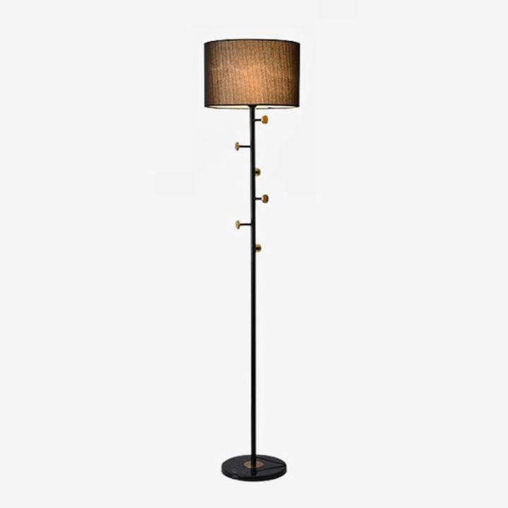 Slim black floor lamp with brown fabric drum shade and gold-tone details