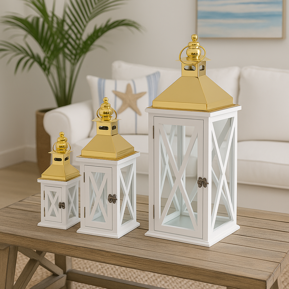 Set of three white wooden lanterns with glass panels and gold metal tops, coastal decorative lanterns.