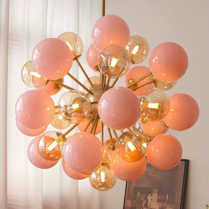 Pink and amber Sputnik globe chandelier with a gold-tone frame in a stylish living room