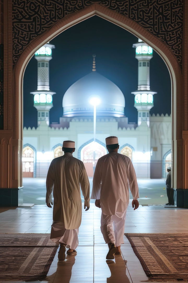 Wadi Home artwork: Two men in traditional attire walk towards a mosque at night through an ornate archway.