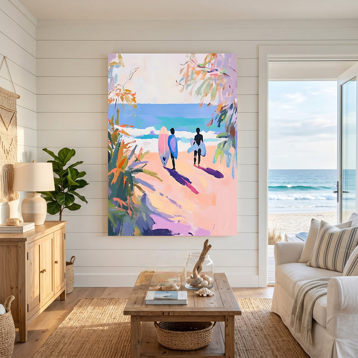 Wadi Home artwork: Two surfers with surfboards walk towards the ocean on a pink sandy beach, impressionistic style with pink, yellow, and blue hues.