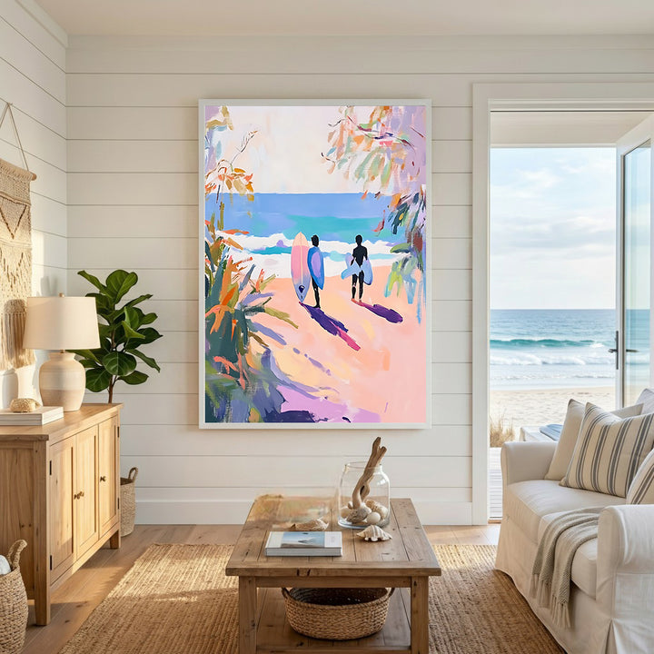 Wadi Home artwork: Two surfers walk towards the ocean on a beach with pink sand, carrying surfboards. Impressionistic style with vibrant pink, yellow, and blue colors.