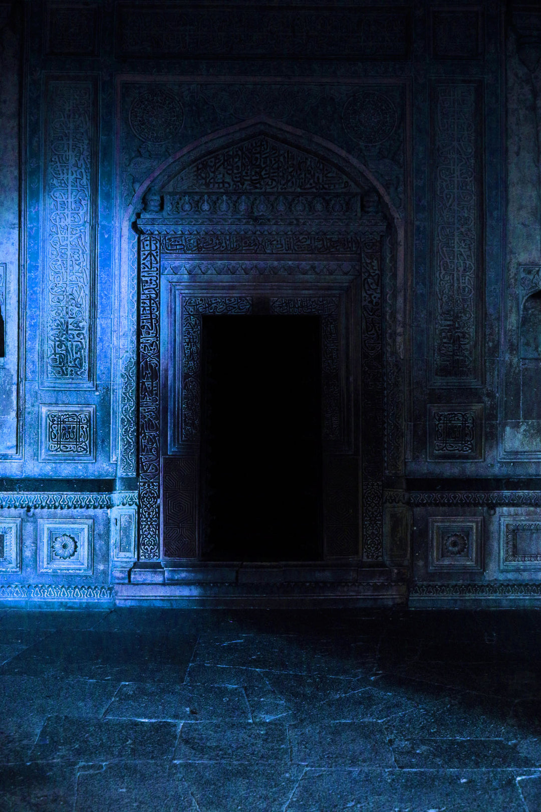 Wadi Home Mysterious Archway Wall Art featuring a dimly lit ornate archway bathed in ethereal blue light, creating a dramatic focal point.