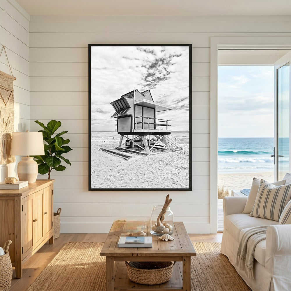 Wadi Home black and white framed print of a lifeguard tower on a sandy beach under a cloudy sky.
