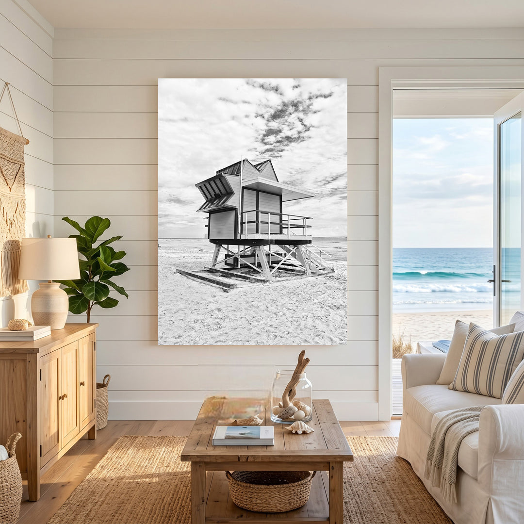 Wadi Home black and white print of a lifeguard tower on a sandy beach under a cloudy sky.