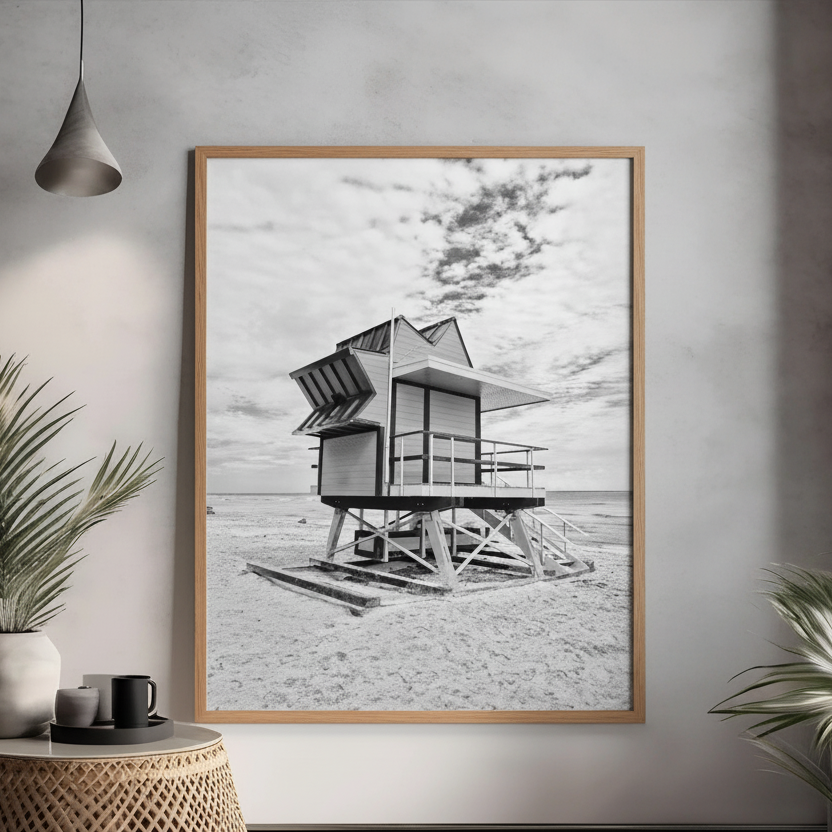 Black and white beach hut on sand with minimalist coastal scenery