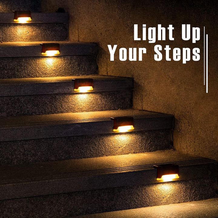 Compact dark solar step light glowing on wet outdoor steps in the rain