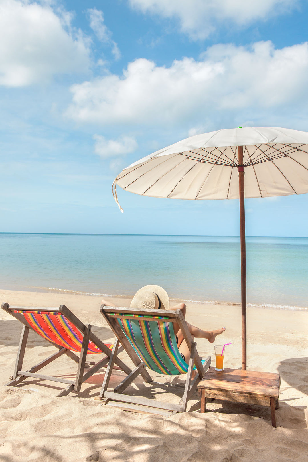 Wadi Home Tropical Beach Scene Wall Art with two colorful lounge chairs, umbrella, and ocean view.