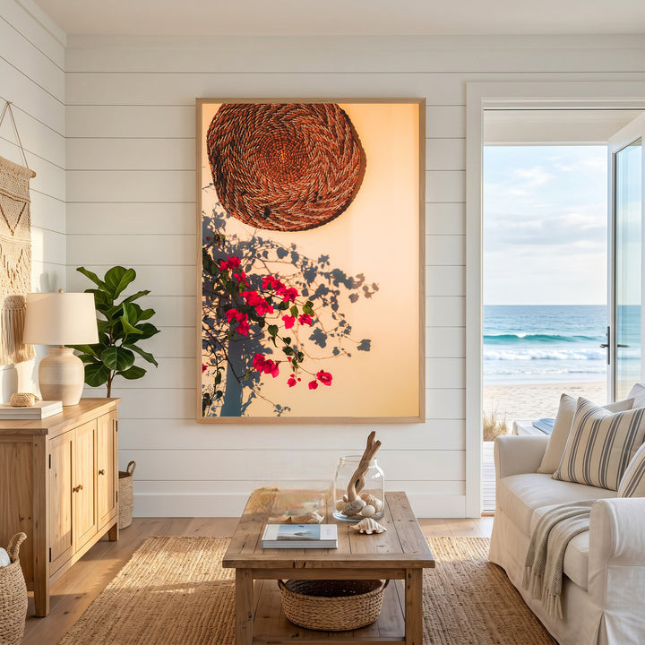 Wadi Home woven basket and vibrant pink bougainvillea wall art with natural shadows, framed in light wood.