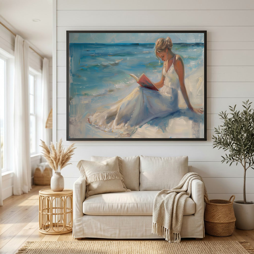 Wadi Home canvas art of a woman in a white dress reading a book on a serene beach with blue ocean waves.