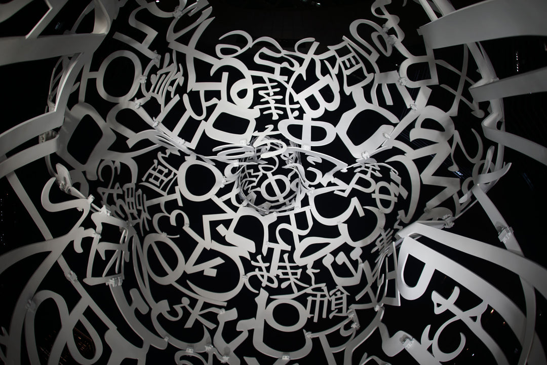 Wadi Home abstract monochrome typography face wall art print with intricate letters and symbols forming a human face.