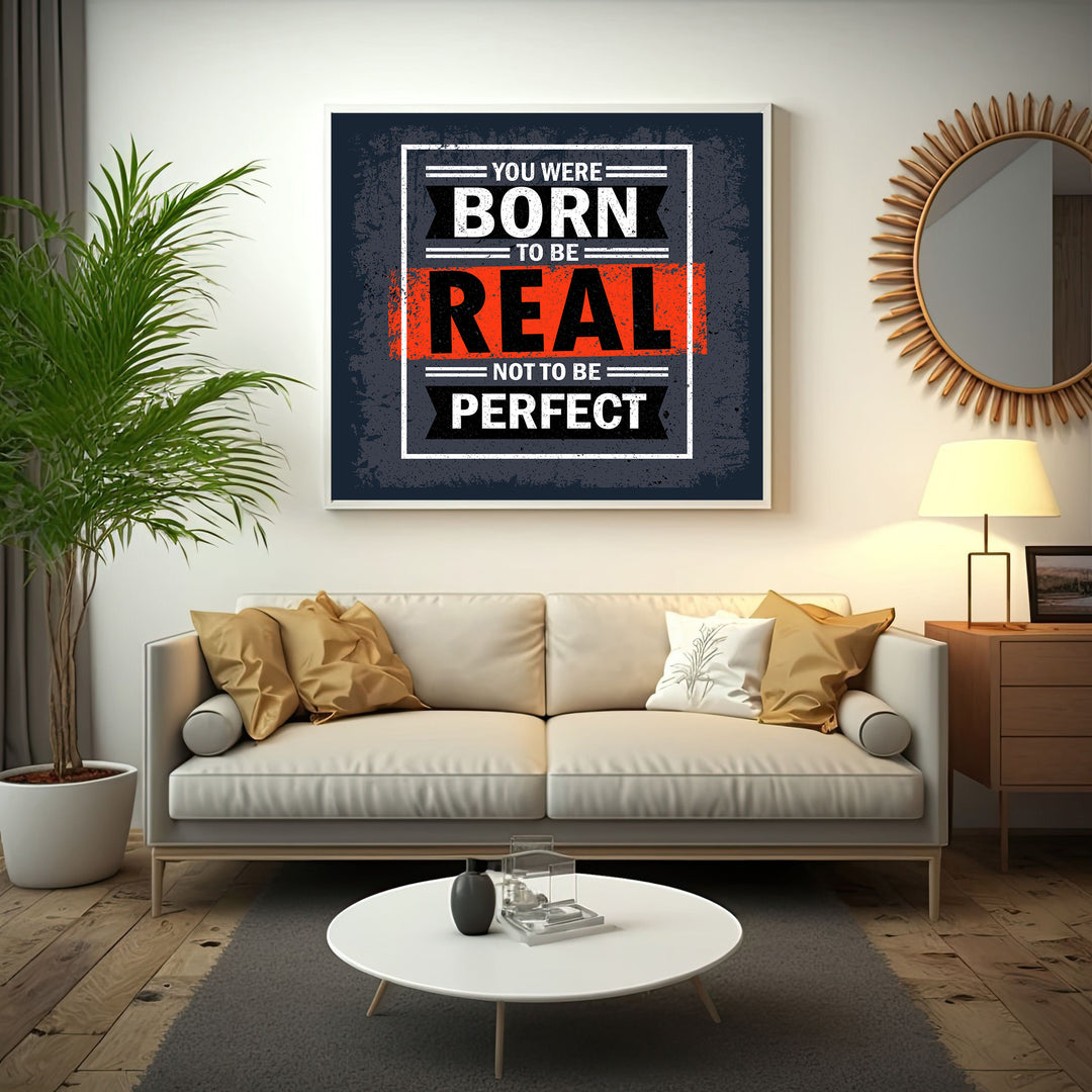 Wadi Home motivational wall art with bold text 'You Were Born To Be Real Not To Be Perfect' in black, white, and orange.
