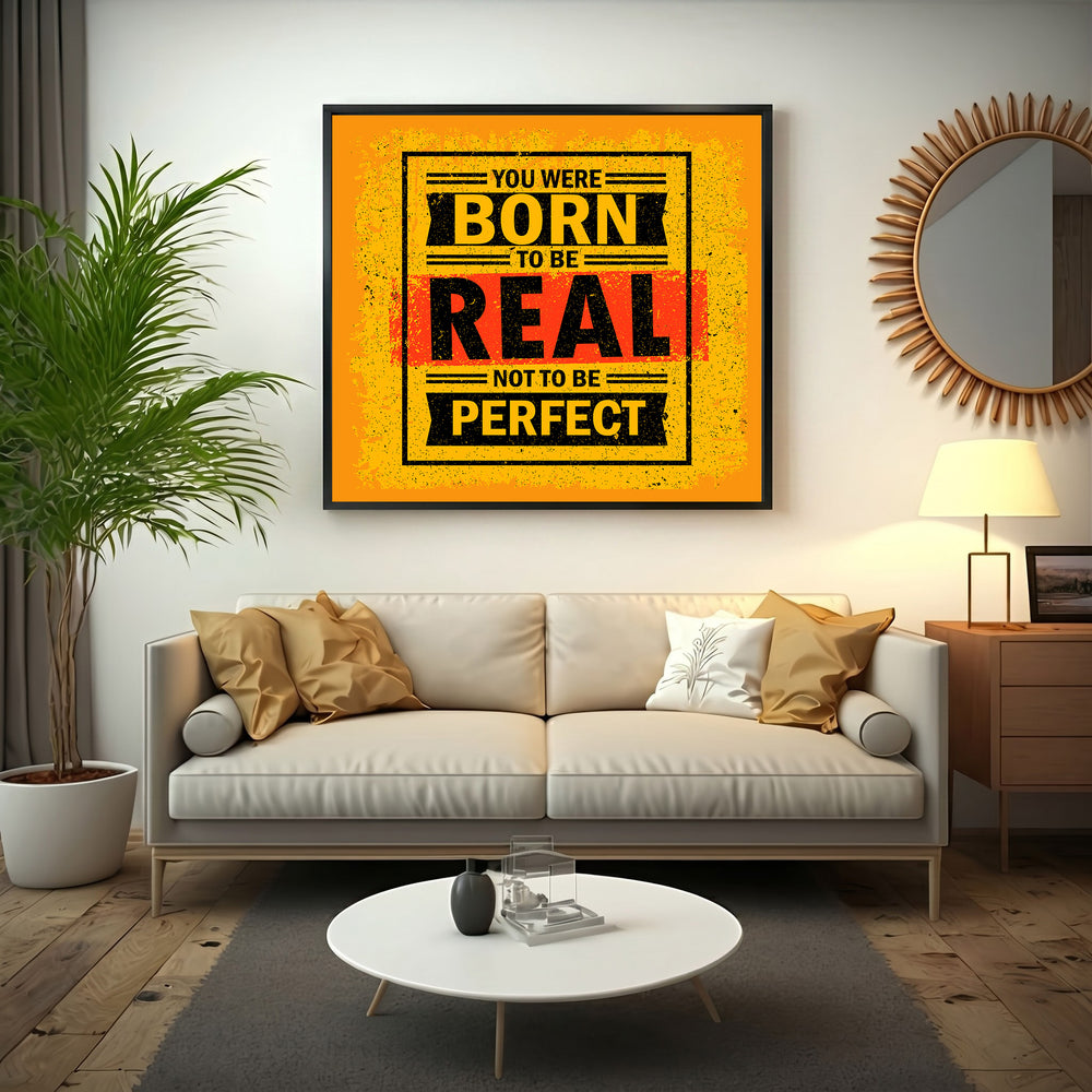 Wadi Home motivational wall art with bold yellow, black, and red typography reading 'You Were Born To Be Real Not To Be Perfect'.