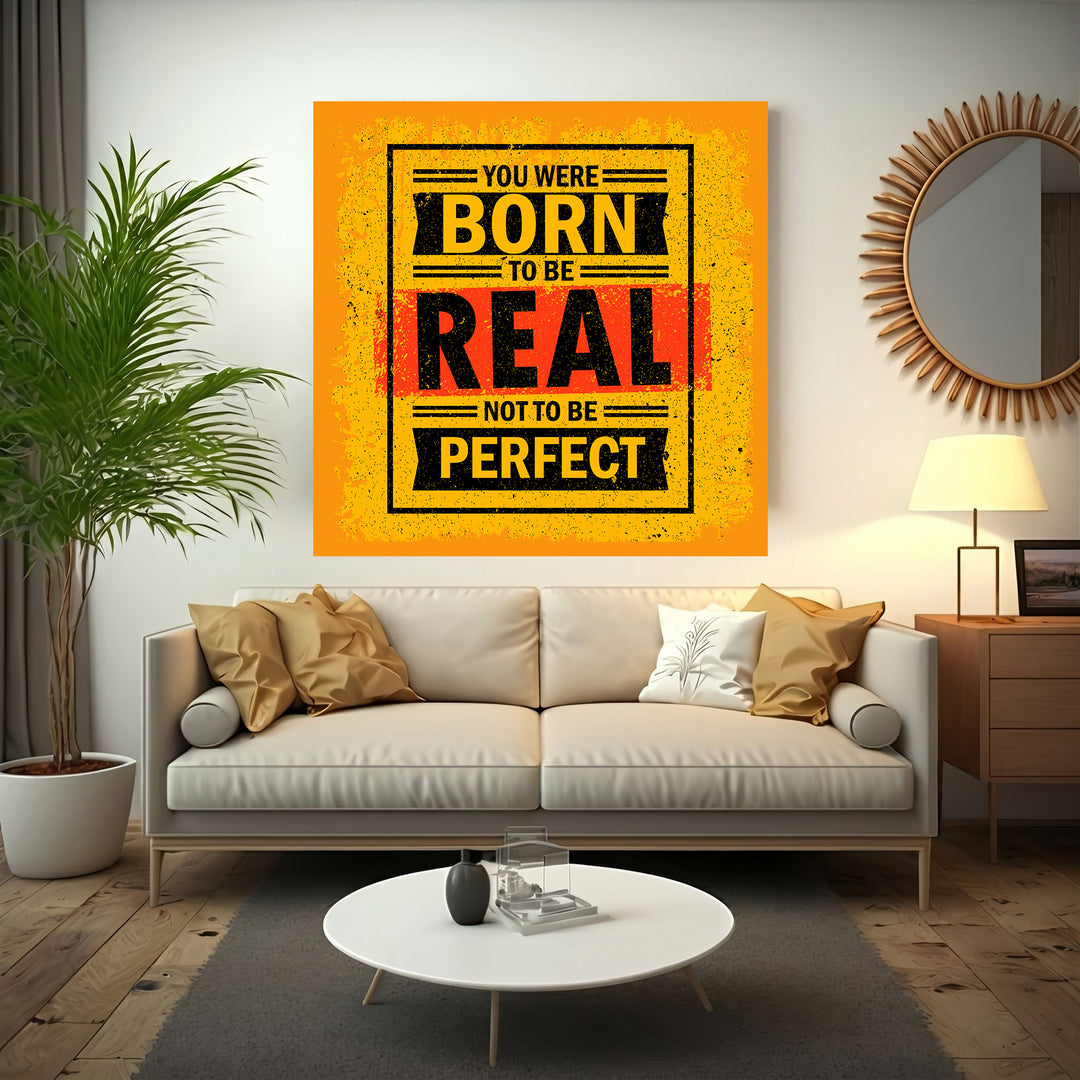 Wadi Home motivational wall art with bold yellow, black, and red typography reading 'You Were Born To Be Real Not To Be Perfect'.