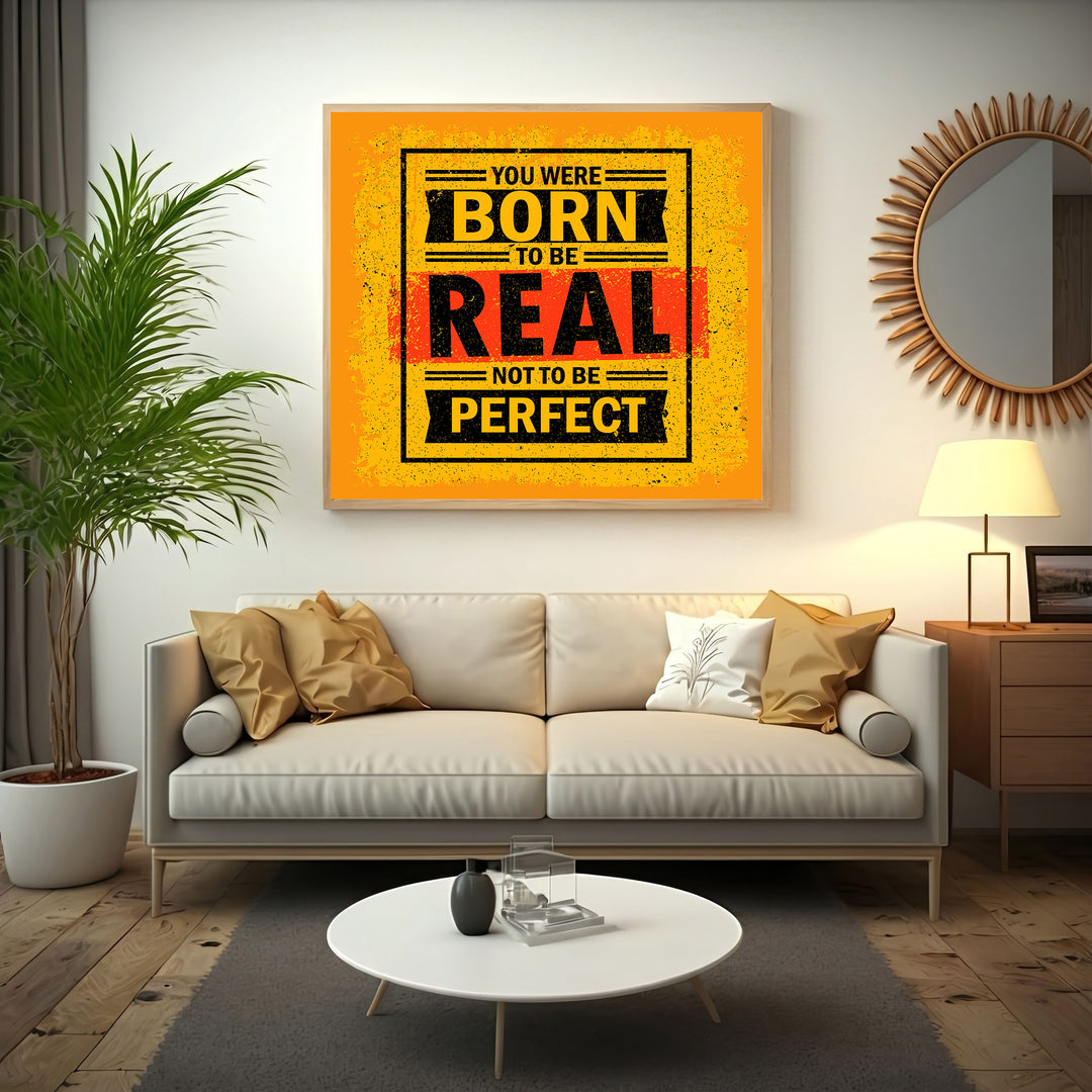 Wadi Home motivational wall art with bold yellow, black, and red typography reading 'You Were Born To Be Real, Not To Be Perfect'.