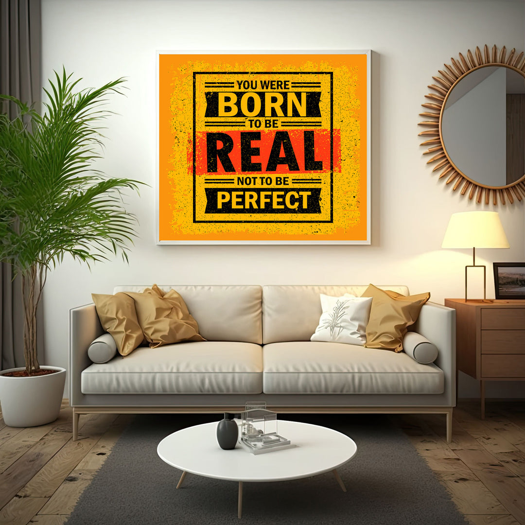 Wadi Home motivational wall art with bold yellow, black, and red typography reading 'You Were Born To Be Real Not To Be Perfect'.