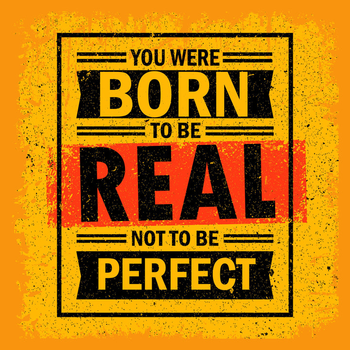 Wadi Home motivational wall art with bold yellow, black, and red typography reading 'You Were Born To Be Real Not To Be Perfect'.
