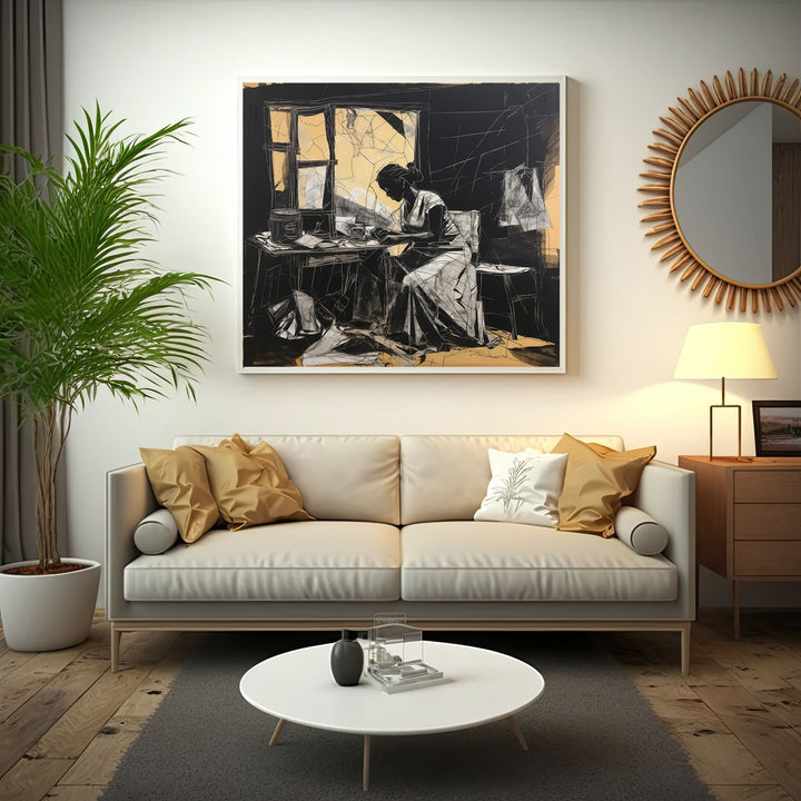 Wadi Home framed black and white sketch art of a woman working at a table with golden accents.