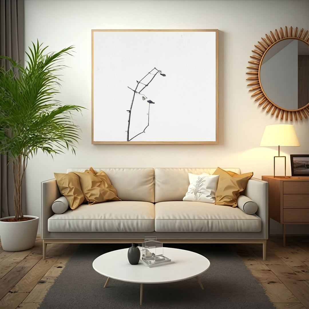 Wadi Home framed minimalist art print of dark branches on a white background, with a light wood frame.