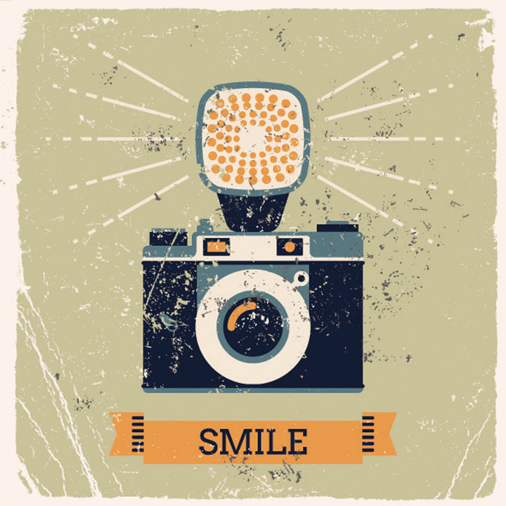 Wadi Home vintage camera wall art print with distressed texture and SMILE banner displayed in a modern living room.