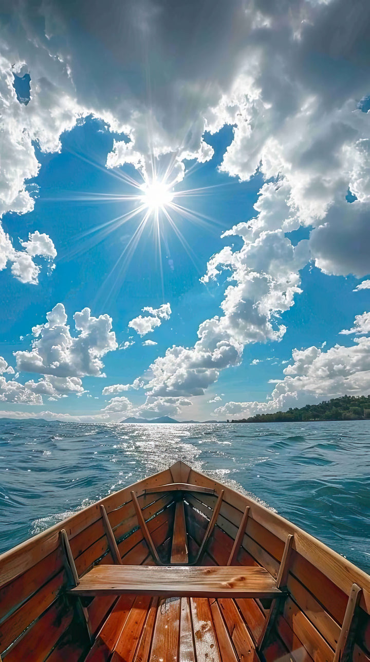 Wadi Home wooden boat art print, view from inside the boat looking out at a bright blue sky with clouds and sun over the water.